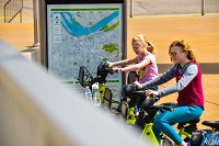 Nichole, 13, and Hailey Gill, 10, test out the comfort and adjustable heights of the bikes at the LouVelo Station at Big Four Landing in downtown Jeffersonville. | STAFF PHOTO BY TYLER STEWART