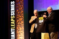 Purdue University President Mitch Daniels, left, presents U.S. Secretary of the Agricuture Sonny Perdue with a t-shirt following their conversation Tuesday at the school. Photo by Nikos Frazier