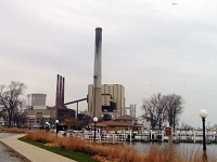NIPSCO's coal-fired Michigan City Generating Station stands near the Washington Park marina on the Lake Michigan shoreline. NiSource plans to reduce greenhouse gas emissions from electricity generation by 90 percent by 2030, as compared by 2005, including by taking its coal-fired plants offline. Staff photo by Doug Ross
