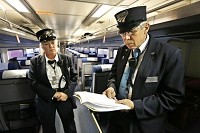 Assistant Conductor Pam Fogarty looks on as Conductor J.R. Richardson looks over a schedule of arrival times Wednesday, November 6, 2013, as Amtrak's Hoosier State train approaches Monon. Staff photo by John Terhune