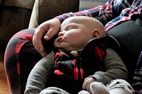 Three month old Austin Glines rests nestled into his mother Heather Glines at their home in Ladoga, Indiana on Tuesday, February 5, 2019. Staff photo by Lindsay Moore