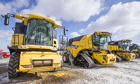 These are new combines sitting outside Burnips Equipment Co. in Wyatt. The market for new farm equipment is weak right now because most farmers are struggling to make a profit. Staff photo by Robert Franklin