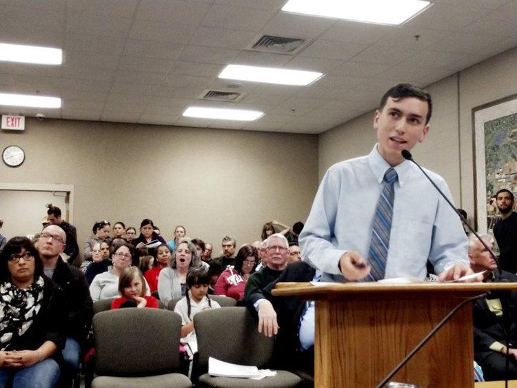 Goshen City Council Youth Adviser Felix Perez-Diener leads a presentation in support of a resolution to make the city government more environmentally conscious during the council meeting Tuesday. The meeting was crowded with a mix of children, teens and adults, many in support of the resolution. Staff photo by Aimee Ambrose