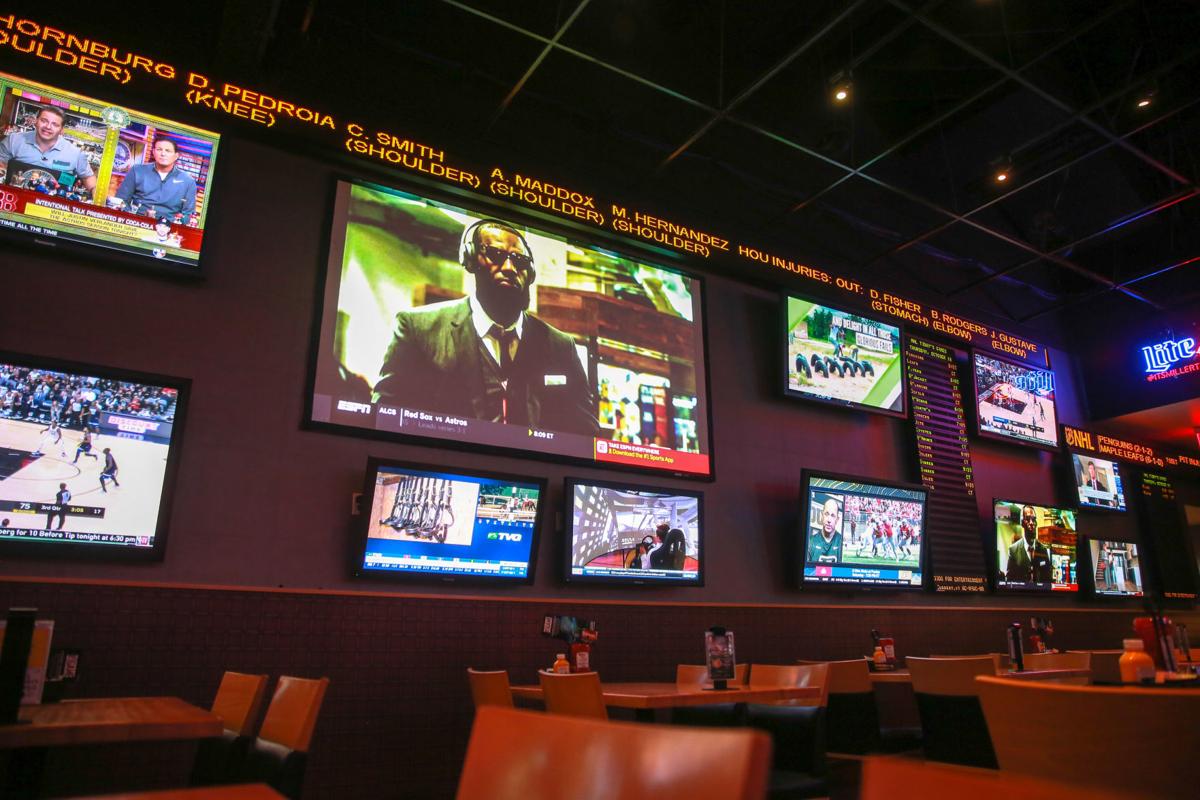 Tickers give sports information at Michigan City's Blue Chip Casino in its The Game sports bar. Tickers also display news and betting odds. Staff file photo by John J. Watkins