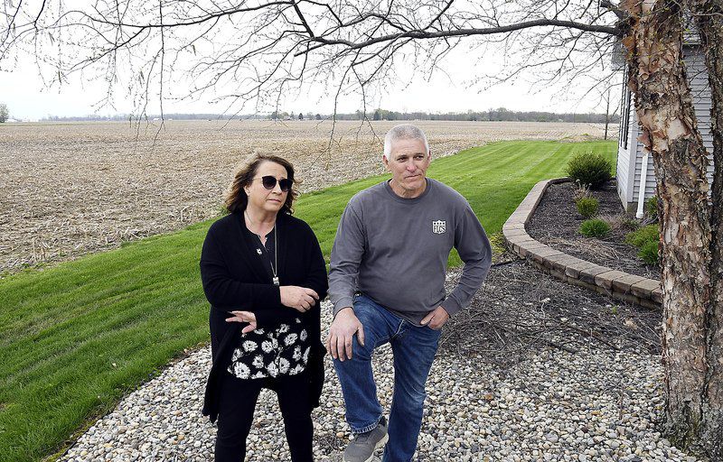  Becky and Curt Harrison aren’t happy about part of the proposed 850-acre solar farm being located directly north of their home on CR 450W. The Harrison’s moved into their home 44 years ago, the day after they got married.  Photo by John P. Cleary | The Herald Bulletin