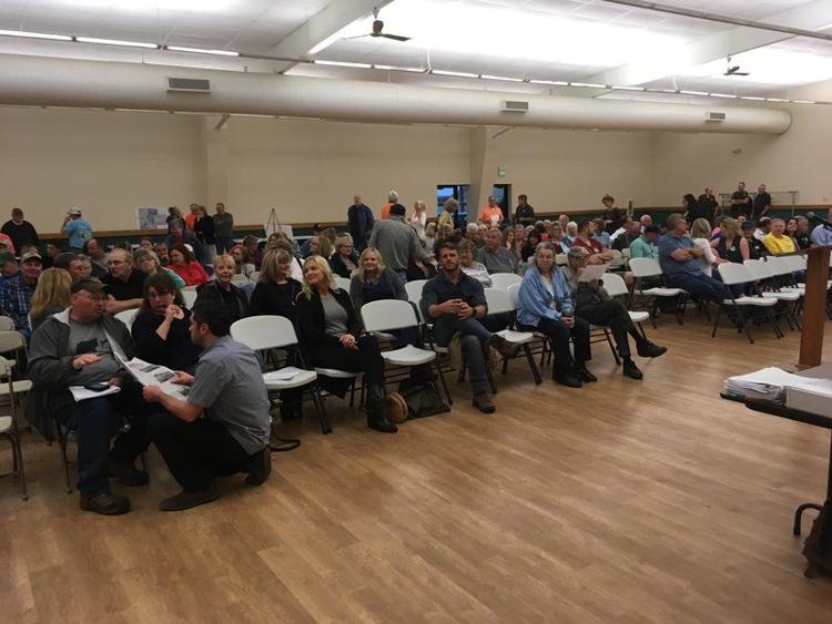 Residents start to gather in the 4-H Fairgrounds exhibit hall in Alexandria before the Madison County Board of Zoning Appeals meeting Thursday evening. The board listened to more statements in support and opposition of a proposed solar farm before setting a May 28 meeting for an expected vote. Staff photo by Ken de la Bastide