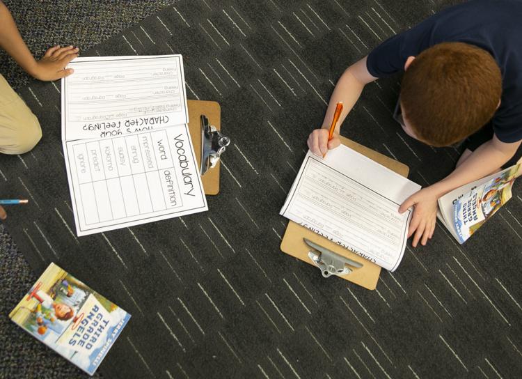 Students work on an assignment at Swanson Traditional School on Thursday. South Bend Community School Corp. will likely seek a taxpayer referendum next year. The district is expected to face an additional $10 million loss in property tax revenue as a result of state-mandated tax caps taking full effect in the county. Tribune Photo/SANTIAGO FLORES 