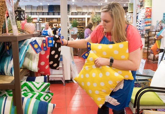 Amanda McMillian pulls pillows for a customer at Pier 1 Imports Saturday, May 25, 2019. McMillian works 15-18 hours per week at Pier 1 Imports in addition to teaching Family and Consumer Sciences at North High School.  (Photo: MaCabe Brown / Courier & Press)