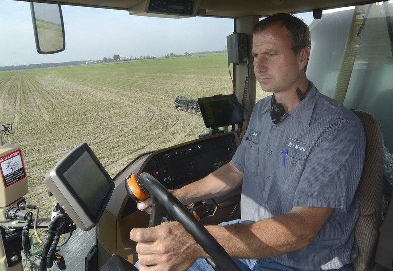 Catching up: Farmer Brad Burbrink, an owner in BE N AG Family Farm in southeast Vigo County, sprays herbicide on one of his fields near Blackhawk on Friday. Tribune-Star/Joseph C. Garza