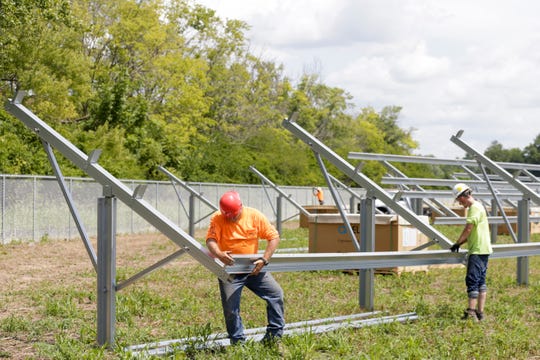 Paul Rich III, left, and Damian High assemble solar panel post in a field along U.S. 231 in Purdue's Discovery Park district between State st. and Airport road, Thursday, Aug. 8, 2019 in West Lafayette. The 10-acre plot owned by Purdue Research Foundation will become a 1.6 megawatt solar power plant for Duke Energy. (Photo: Nikos Frazier | Journal & Courier)