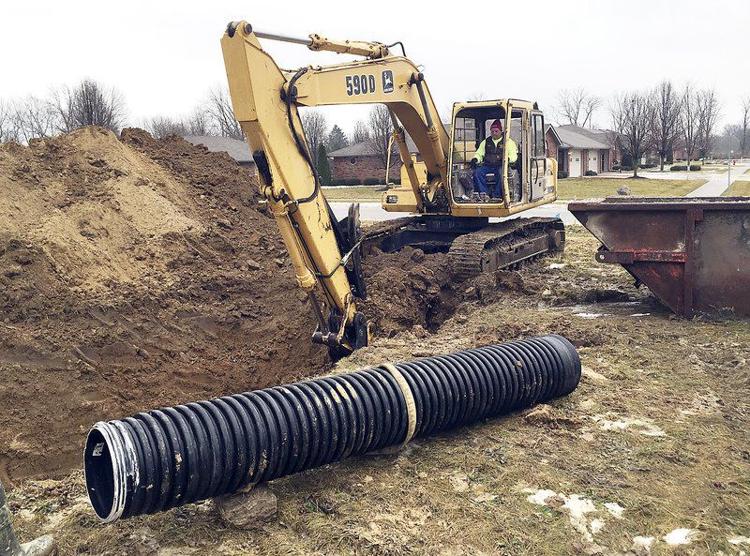 Crews with Chuck Johnson Construction work in January 2018 to relocate a storm water drain in South Main Village in Anderson for a new house to be constructed. CNHI News Indiana file photo by Ken de la Bastide,| The Herald Bulletin