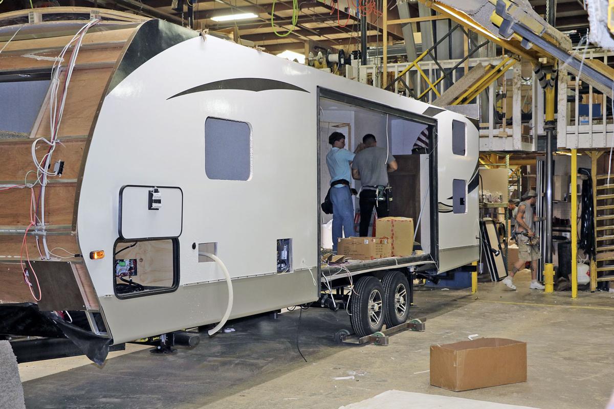 Employees at Keystone RV’s Plant 31 in Goshen, Indiana, work to complete a travel trailer in this August 2019 file photo. The RV industry is being watched by economists because of its history of being a bellweather for the nation’s economy. John Kline | The Goshen News
