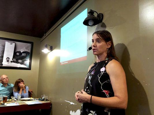 Indiana University Northwest Prof. Erin Argyilan discusses Lake Michigan's record high water levels and how they affect local beach erosion during a presentation Thursday at Shoreline Brewery. Northwest Indiana Green Drinks hosted the event, which drew nearly 100 guests. Staff photo by Photo by Ted Yoakum