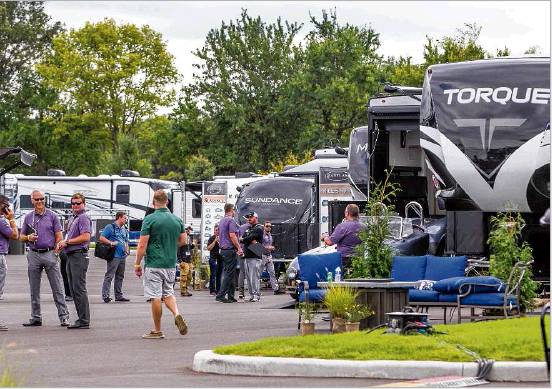 People check out RVs on display during the Elkhart RV Dealer Open House on Tuesday. Thousands of the latest models are on display for dealers across the country. Staff photo by Robert Franklin
