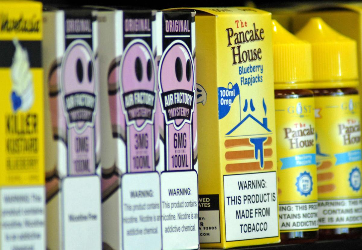KC Vapor Studio in Lebanon has a variety of flavored liquids that can be loaded into an e-cigarette or vaping device, including one named Pancake House and a variety of fruit flavors, with and without nicotine. Staff photo by Maria Flora