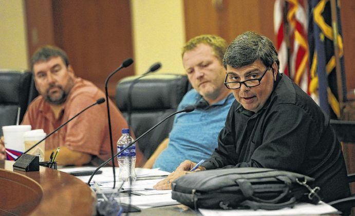 County commissioners Marc Huber, left, John Jessup and Brad Armstrong, right, discuss changes to language in the Hancock County ordinance. Staff photo by Tom Russo