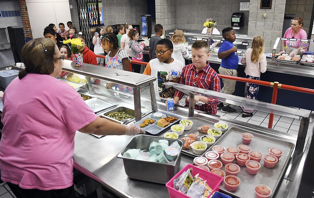 Fourth graders

go through the line in the cafeteria at Valley Grove Elementary School in Anderson on a recent Friday to get their lunch of lasagna, chicken nuggets or hamburgers. A new report ranks Indiana 13th in the rate of childhood obesity.  CNHI News Indiana photo by John P. Cleary