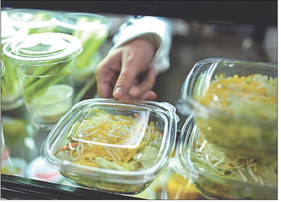 A student selects a salad while passing through the lunch line. | STAFF PHOTO BY TYLER STEWART