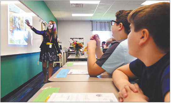 First-year teacher Jenny Miller conducts her fifth-grade class on the first day of school at Anderson Intermediate School. Fresh out of college, Miller said she always wanted to be an educator. Staff file photo by John P. Cleary