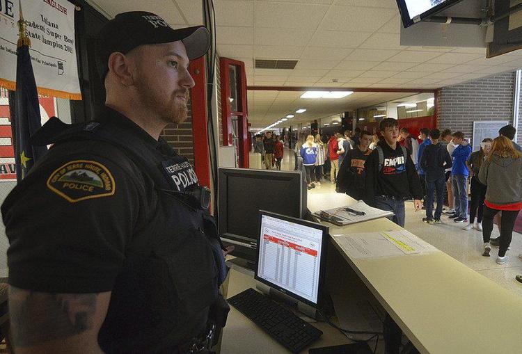 Protecting the students: Terre Haute Police Department patrolman Bryan McKinney mans the School Protection Officer desk at the front entrance to Terre Haute South High School on Friday. Staff photo by Joseph C. Garza