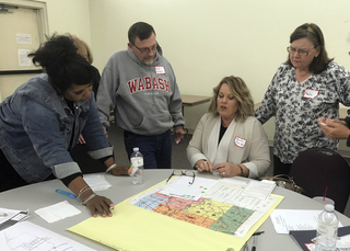 Participants in Thursday’s Bright Ideas meeting gather around a map of the south end of Fayette County and discuss one group’s ideas for howthe area could be enhanced. From left are Cynthia Hunt, Rod Denman, Marsha Eldridge and Mary-Lou Branson. Staff photo by Bob Hansen