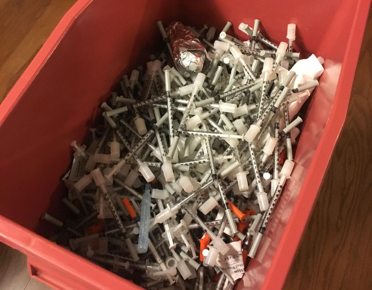 Syringes fill a large sharps container at the Indiana Recovery Alliance at 118 S. Rogers St. in 2016. (Abby Tonsing / Herald-Times)