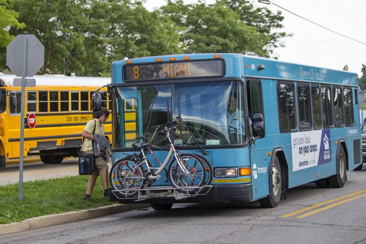 A Transpo bus stops at a pickup location recently near Riley High School. The South Bend Common Council Tuesday passed a resolution supporting the Pete Buttigieg administration’s climate change action plan, which includes a call for heavier use of Transpo to reduce the number of vehicles emitting carbon into the atmosphere. South Bend Tribune Photo/MICHAEL CATERINA