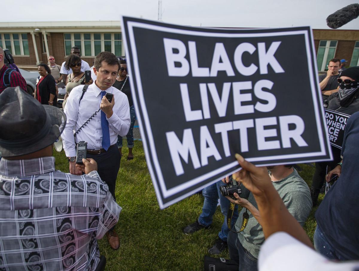 South Bend Mayor Pete Buttigieg listens to questions from protesters during a rally June 21 after the shooting of Eric Logan by a police officer. Tribune Photo/MICHAEL CATERINA