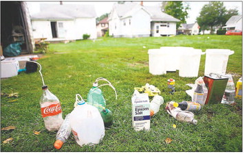 Parts of a meth lab sit on a lawn. Photo contributed