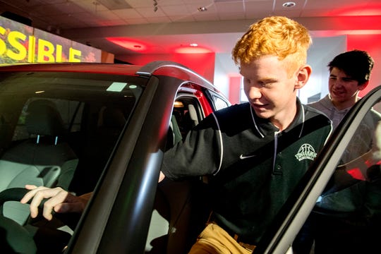 Wood Memorial High School Sophomore Luke Shenks climbs into a new Toyota Highlander during launch at Toyota Motor Manufacturing Indiana Friday morning, Jan. 17, 2020. (Photo: MaCabe Brown / Courier & Press)
