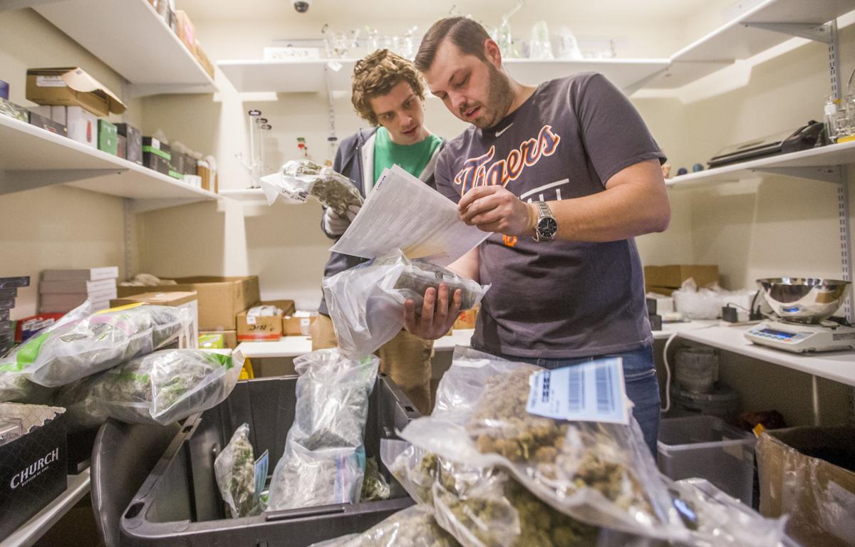 Managers Nick Ghezzi, left, and George Pittenturf work on a shipment of marijuana inside the ReLeaf Center on Wednesday in Niles. Recreational marijuana sales start today in Niles. Staff photo by Robert Franklin