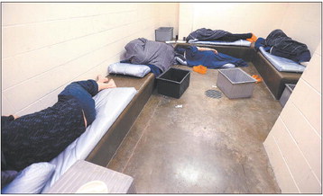 Five inmates sleep in one of the holding cells at the Howard County Criminal Justice Center. Staff photo by Tim Bath | Kokomo Tribune