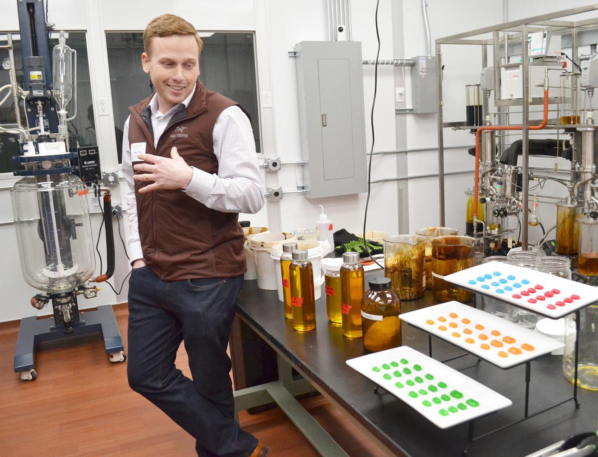 Heartland Harvest Processing owner Adam Kline describes the finished products of CBD oil, isolate and gummy candles, to the tour group at the new facility in Gas City. Staff photo by Leeann Doerflein