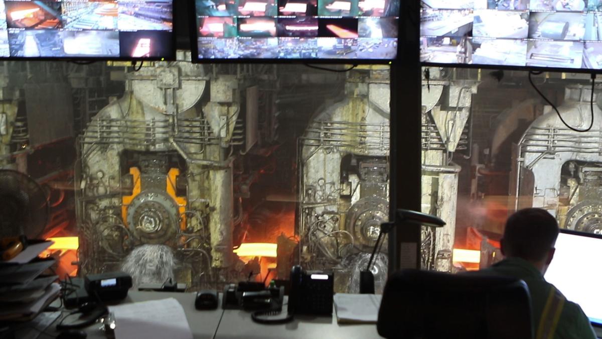A view from the control room at ArcelorMittal Indiana Harbor shows a bar of steel making its way through the 80-inch hot strip mill on its way to becoming a coil of steel.  Staff file photo by John J. Watkins