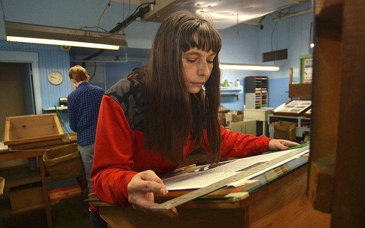 Final layout: Page designer Rachael Clements lays out a page for the last edition of the Daily Clintonian on Friday in Clinton. Staff photo by Joseph C. Garza