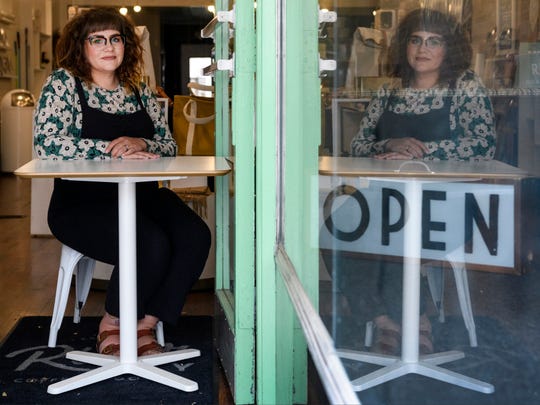 Heather Vaught, owner of River City Coffee + Goods, sits at the door of the shop’s Main Street storefront in Downtown Evansville, Ind., Saturday morning, April 25, 2020. The business is currently only open for curbside pick-up or local porch deliveries on Wednesdays and Saturdays from 10 a.m. to noon due to restrictions from the COVID-19 pandemic.  (Photo: SAM OWENS/ COURIER & PRESS)