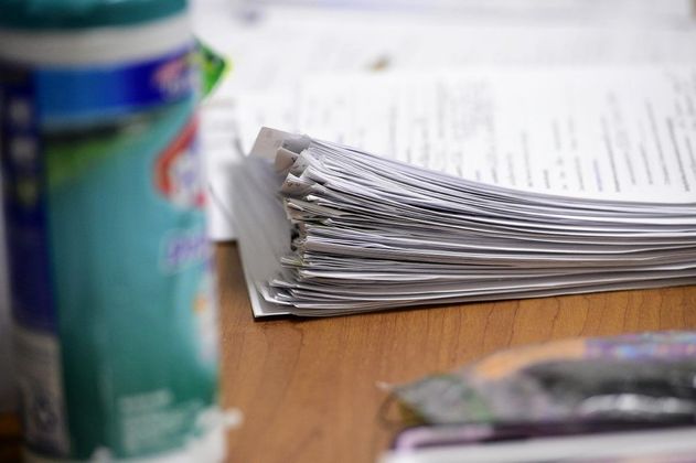 Case files pile up on a desk at the Hancock County Health Department. Staff photo by Tom Russo
