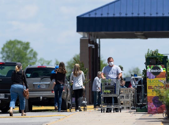 Shoppers visit the East Side Lowe's Home Improvement Wednesday afternoon, May 6, 2020. Some local health officials are afraid residents may feel that social distancing, wearing masks and avoiding crowds of people aren't needed since the state has decided to try to re-open in this time of COVID-19. (Photo: DENNY SIMMONS / COURIER & PRESS)