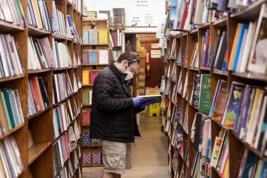 Michael Greenan of Lafayette looks through a book while shopping at Von's Shops, Monday, May 4, 2020 in West Lafayette. (Photo: Nikos Frazier | Journal & Courier)