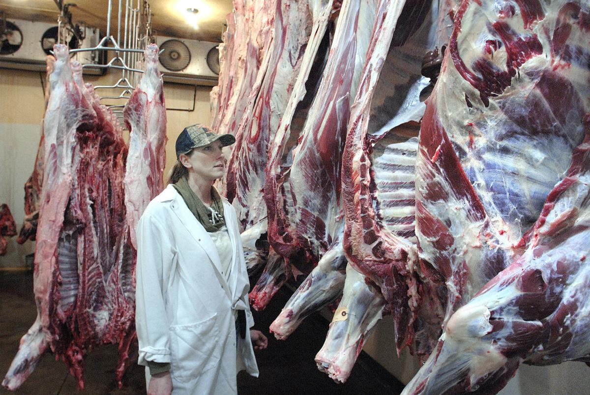 Lori Warfel of Downs, owner of Bittner's Eureka Locker, Inc., in Eureka, Illinois, inventories sides of beef in the meat locker's refrigerated storage, Tuesday, May 12, 2020. Like many smaller meat lockers across the midwest, business is good, if she can locate the products customers want. Photo by DAVID PROEBER LEE NEWS SERVICE
