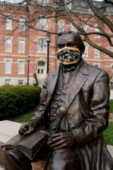 A statue of John Purdue, the founder of Purdue University, is seen wearing a Purdue surgical mask, Tuesday, April 7, 2020 in West Lafayette. (Photo: Nikos Frazier | Journal & Courier)