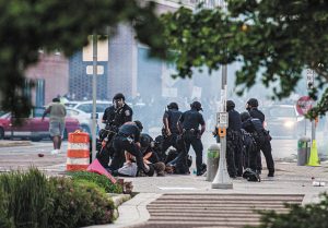 Officers arrest protesters at Alabama and Market streets Saturday night. (IBJ photo/Mickey Shuey)