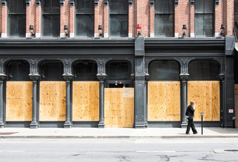 Buildings are covered in plywood to prevent more damage. IBJ photo/Mickey Shuey)