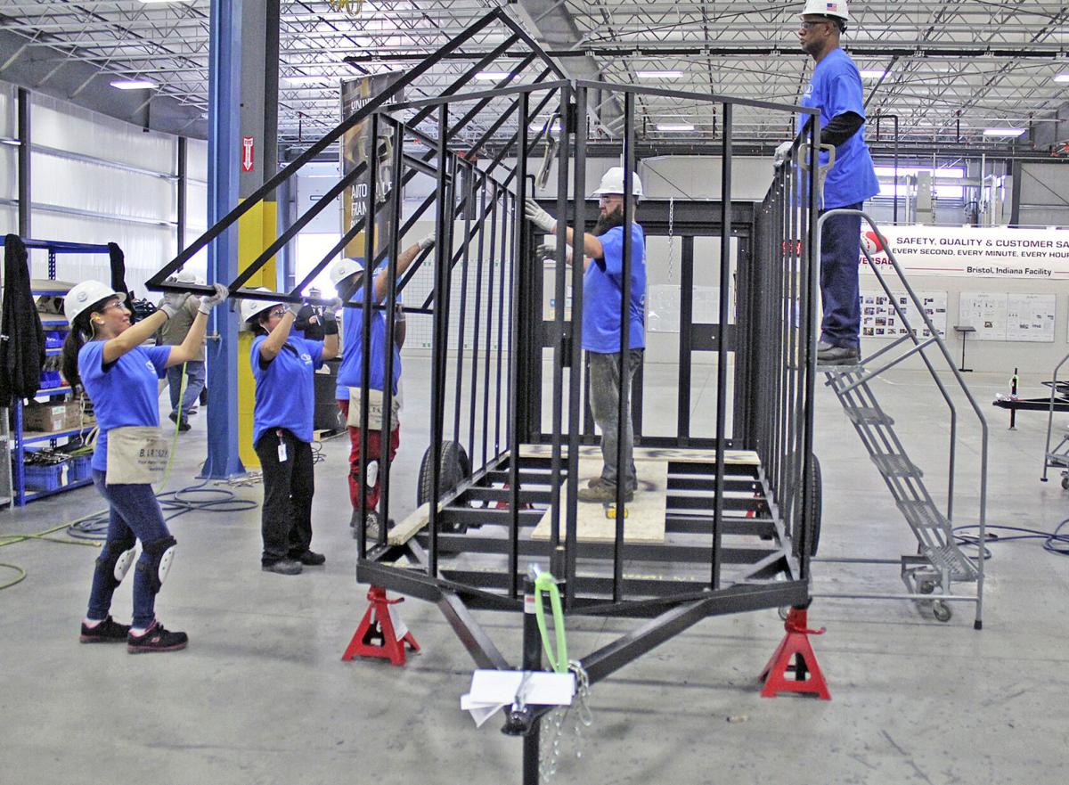 In this March 2017 file photo, a crew of workers raise a roof assembly onto a trailer frame at the Universal Trailer Corp. plant in Bristol. Indiana manufacturing has been slowed by the COVID-19 pandemic and there is no reliable forecast of when the industry will return to pre-pandemic strength, according to several sources. Staff file photo by Roger W. Schneider | The Goshen News