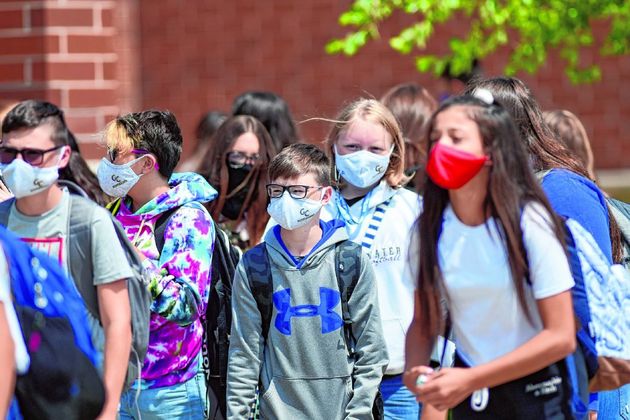 
Greenfield Central Junior High students head for their buses after school on Friday, a day after a student there was found to be infected with the novel coronavirus. (Tom Russo | Daily Reporter)