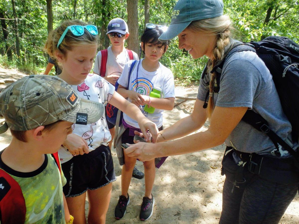 Dunes Learning Center naturalist Anna Gundrum lets campers inspect a snake at a camp held earlier this year. Provided image