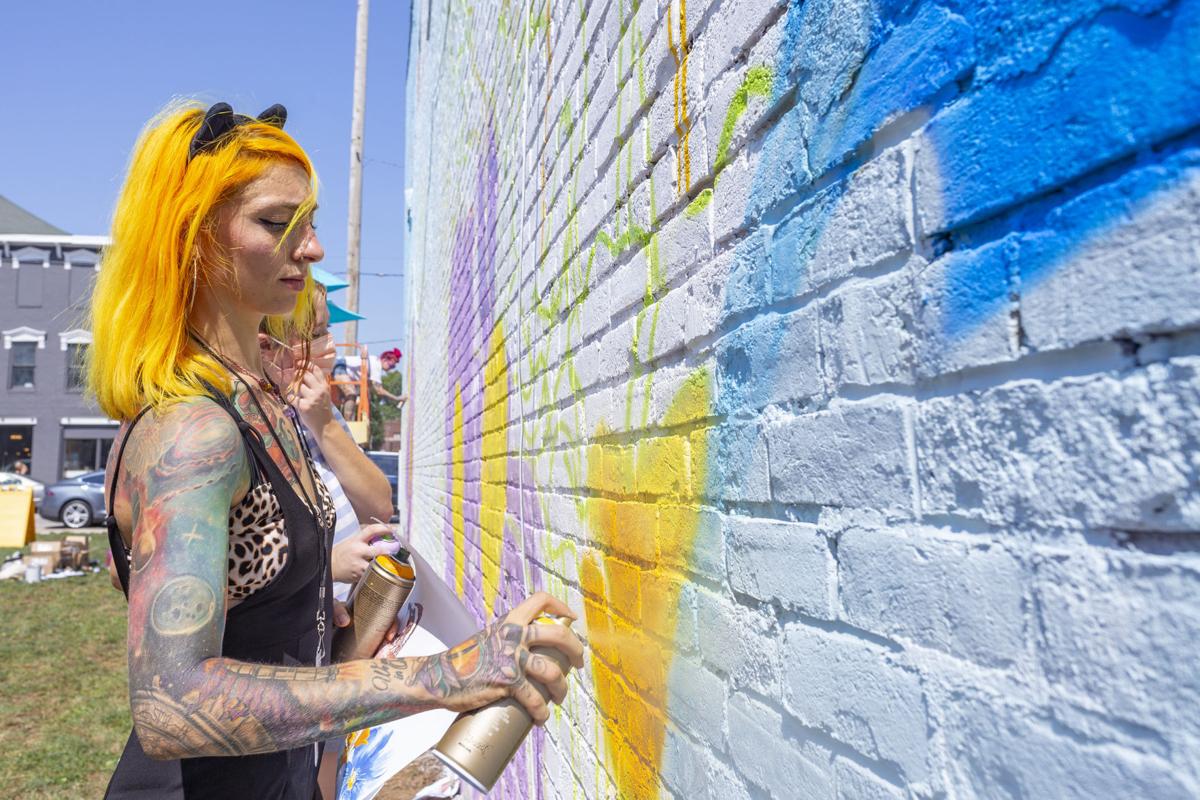 America Carrillo said she uses spray paint to fill in the rough sketch before going back in the brushes to create larger-than-life murals. Staff photo by Andrew Maciejsewski