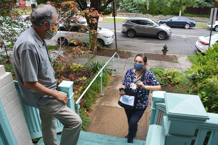A census worker shows her badge at a resident’s front steps July 31 as she canvasses a neighborhood for the 2020 Census. (U.S. Census Bureau / Courtesy photo)