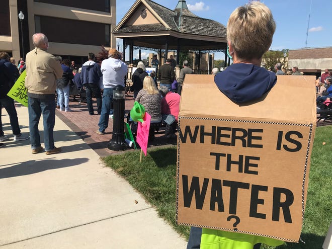 Jill Robbins, a Lake Freeman homeowner, wears a sandwich board reading, 'Where's the water' during a Saturday, Oct. 3, 2020, rally in downtown Monticello aimed at getting federal regulators'  attention over low water levels this summer. Staff photo by Dave Bangert