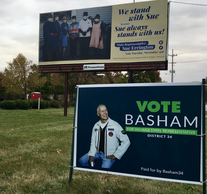 State Rep. Sue Errington, D-Muncie, challenged by Republican Dale Basham, is pictures wearing a mask alongside masked supporters on a billboard near the Cardinal Greenway Depot in Muncie. Staff photo by Seth Slabaugh